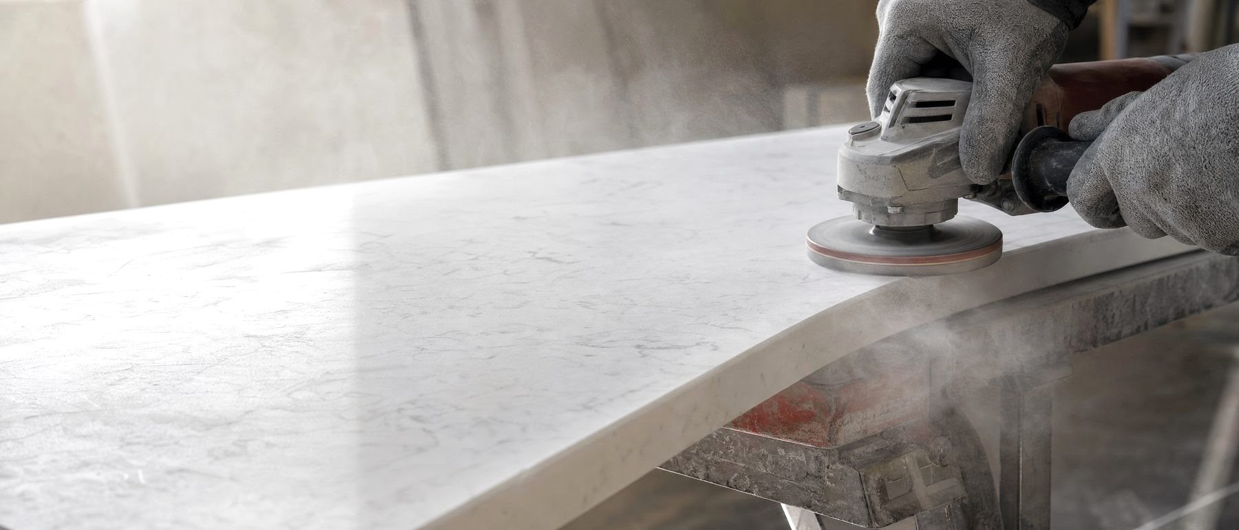 Grinding the edge of an engineered stone countertop throws off fine silica dust, the cause of engineered stone silicosis